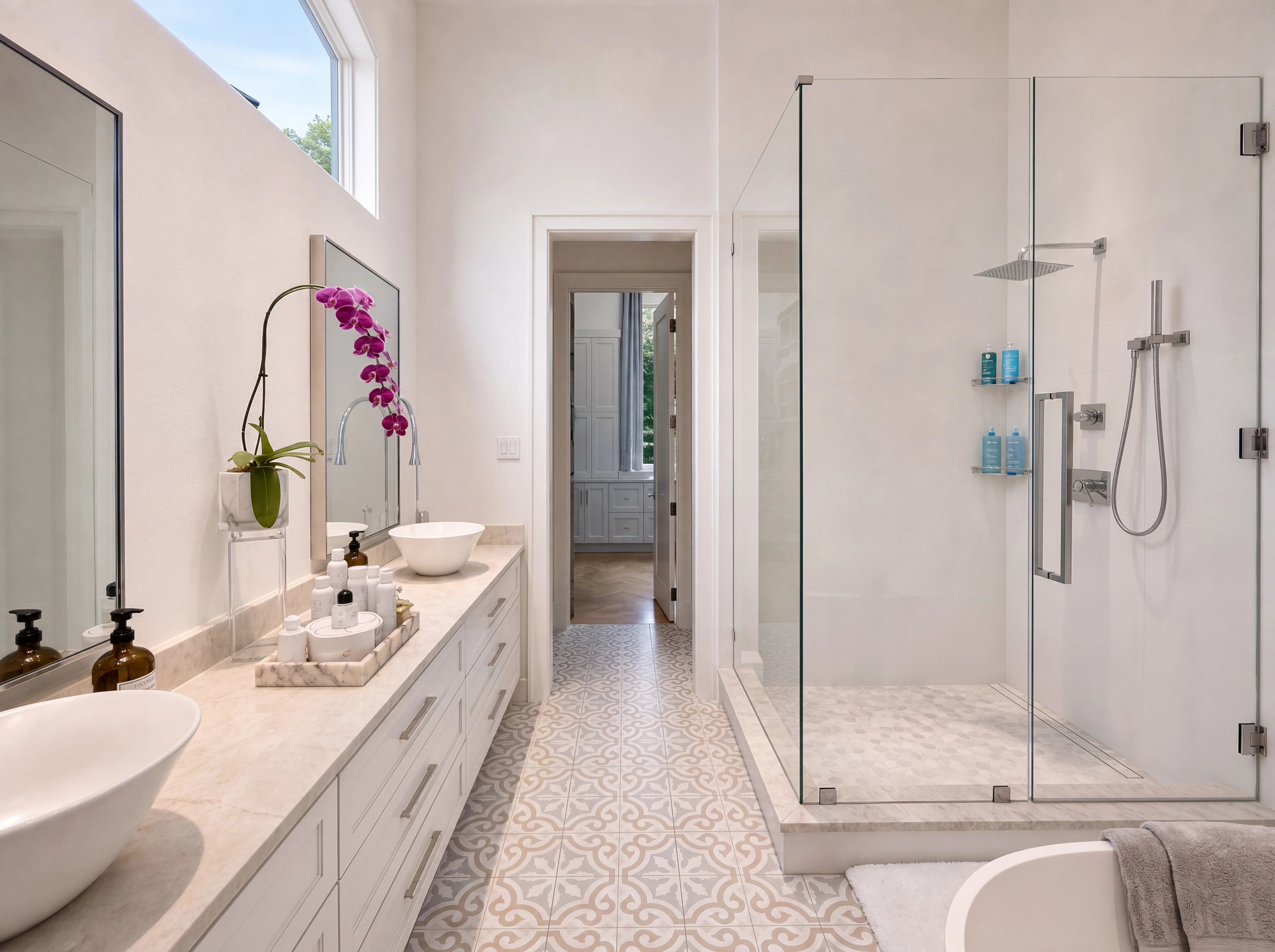 Primary bath with marble counters and freestanding tub